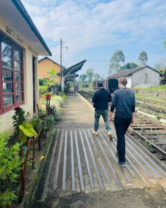 Travellers waiting on a small railway station platform