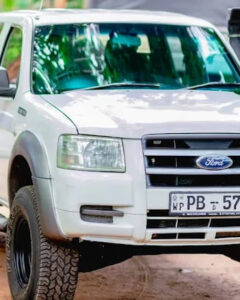 The company four-wheel-drive pickup parked before a tour