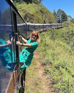 A traveller leaning from the window of a hill-country train