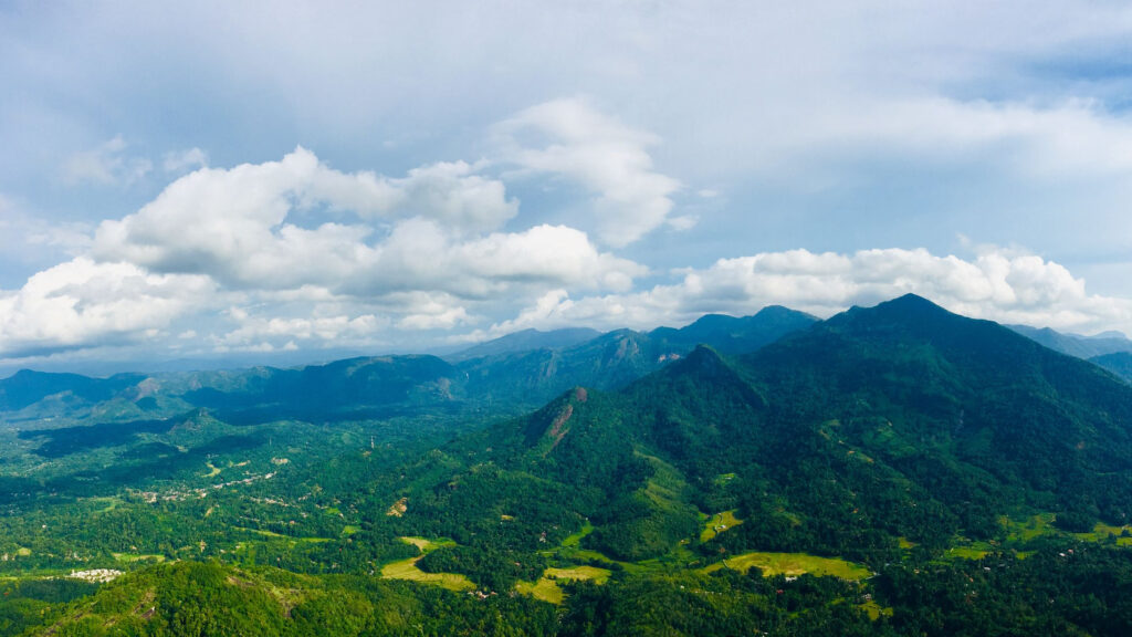 Forested hills, paddy fields and scattered villages across the Sri Lankan hill country